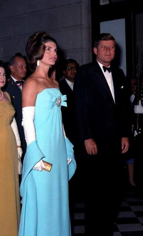 Photographer:   Rowe, Abbie, 1905-1967 Description: First Lady Jacqueline Kennedy holds a silver pitcher presented as a gift for the White House by James Hoban Alexander. Diplomatic Reception Room, White House, Washington, D.C. 